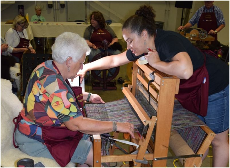 The Ewenique Spinners team weaving their shawl. Photo: Rich Lundquist.